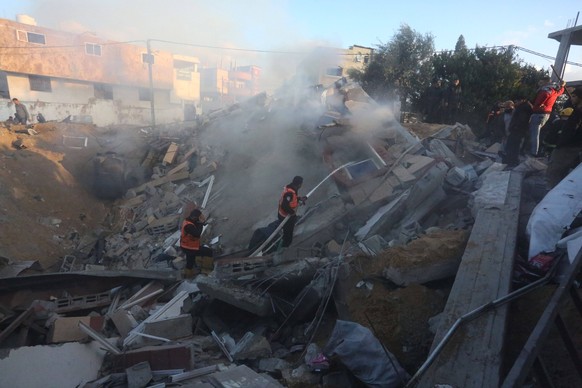 240219 -- GAZA, Feb. 19, 2024 -- People conduct rescue work after an Israeli airstrike in the southern Gaza Strip city of Rafah, on Feb. 19, 2024. The Palestinian death toll resulting from the ongoing ...