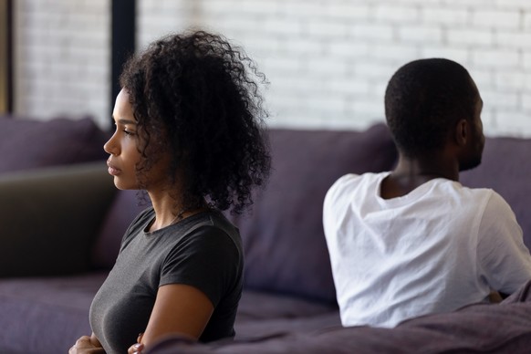 Sad unhappy african wife avoiding talk ignoring husband after couple fight feels indifferent offended, upset frustrated black girlfriend tired of problems, thinking of divorce with selfish boyfriend