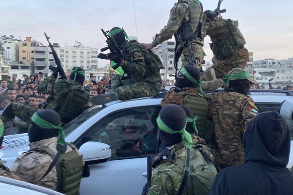 Palestinians gather near the site of the handover of the Israeli hostages to the International Committee of the Red Cross ICRC Palestinians gather near the site of the handover of the Israeli hostages ...