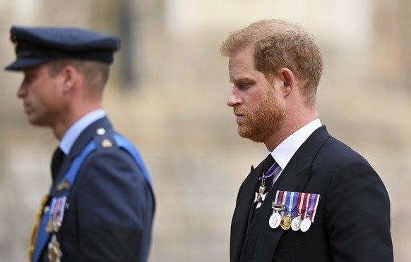 Britain's Prince William and Prince Harry join the Procession following the State Hearse carrying the coffin of Queen Elizabeth II towards St George's Chapel, Windsor, Monday Sept. 19, 2022. (Justin S ...