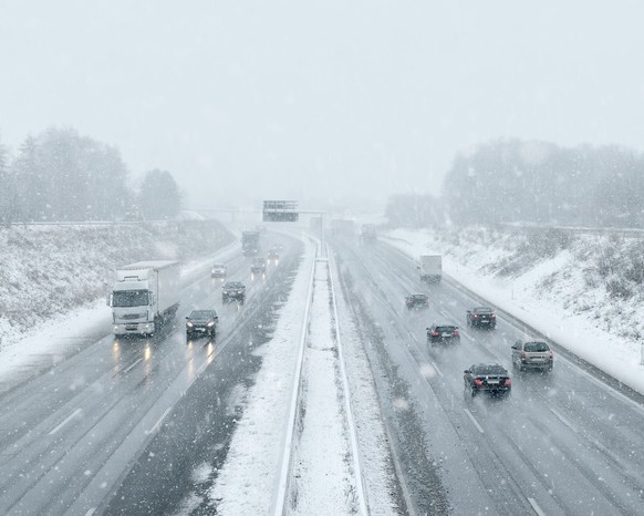 Winter driving - commuter traffic on a highway - expressway - snowfall