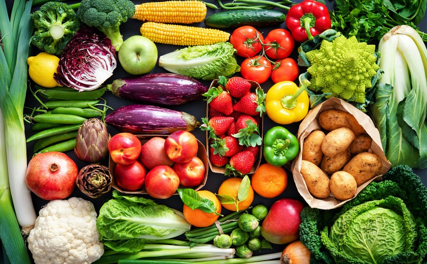 Food background with assortment of fresh healthy organic fruits and vegetables on the table