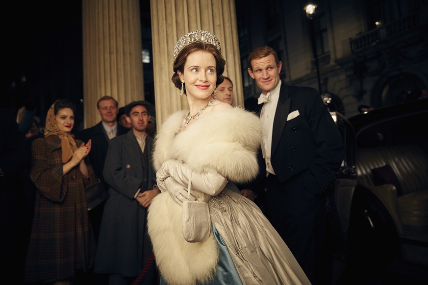 This image released by Netflix shows Claire Foy, center, and Matt Smith, right, in a scene from &quot;The Crown.&quot; (Robert Viglasky/Netflix via AP)