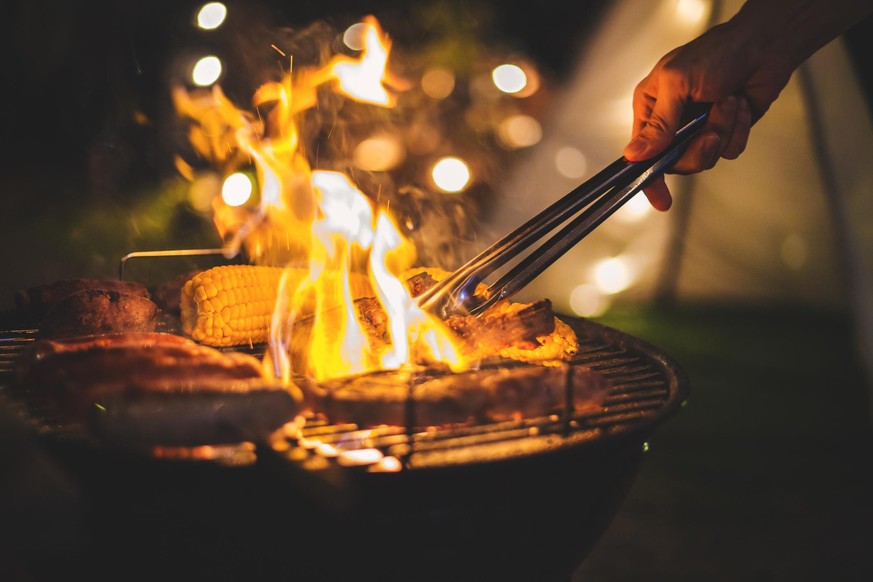 Family making barbecue in dinner party camping at night