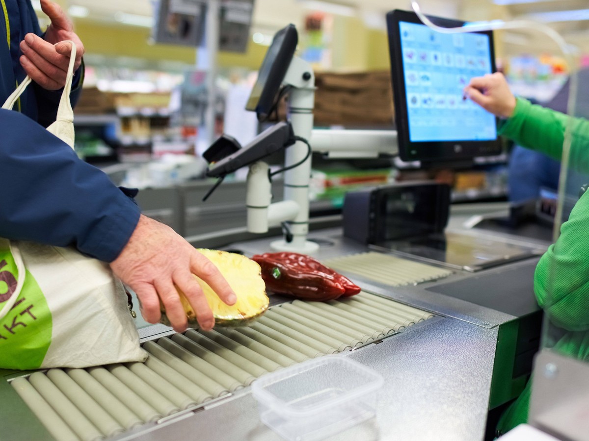 Supermarket in Marktoberdorf, March 24, 2020. A cashier in a grocery store remembers to keep distance between customers due to the Corona virus disease COVID-19 on March 24, 2020 in Marktoberdorf, Ger ...