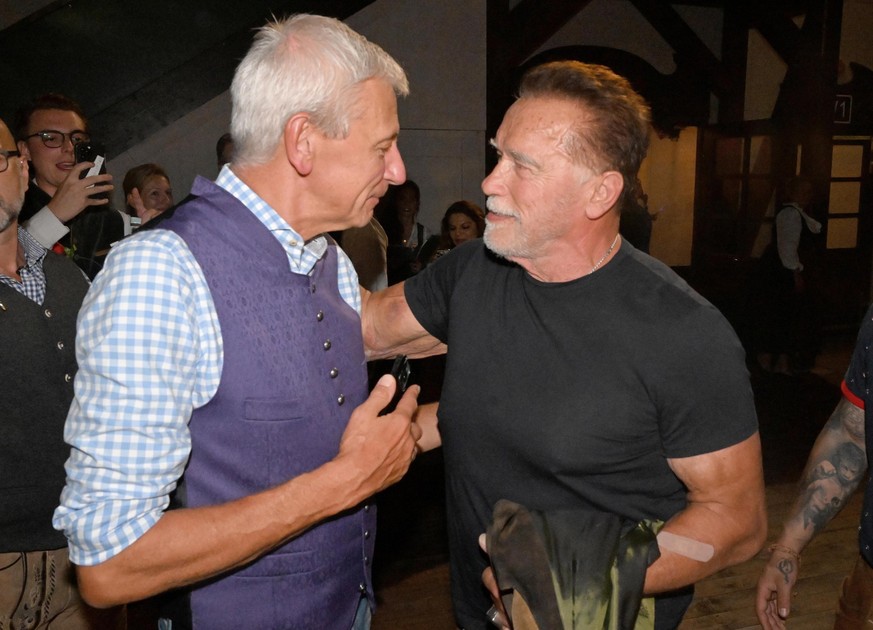 21.09.2023, Bayern, München: Der Wirt des Marstallzelts Siegfried Able (l) spricht dem Schauspieler Arnold Schwarzenegger im Marstallzelt. Die 188. Wiesn findet dieses Jahr vom 16.09.- 03.10.2023 stat ...