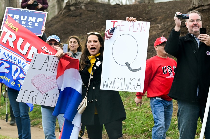 A supporter of U.S. President Donald Trump holds a sign referencing the QAnon conspiracy theory outside the Trump National Golf Club in Sterling, Virginia, U.S. November 22, 2020. REUTERS/Erin Scott