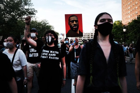 NEW YORK CITY - MAY 25: Black Lives Matter supporters and others march across the Brooklyn Bridge to honor George Floyd on the one year anniversary of his death on May 25, 2021 in New York City. Floyd ...