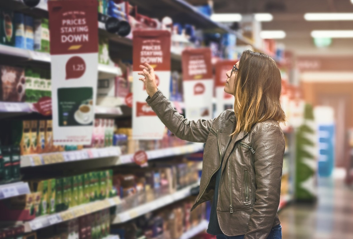 Shot of a young woman shopping at a grocery store