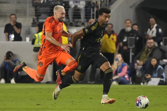 Los Angeles FC midfielder Timothy Tillman, right, gets entangled with Houston Dynamo midfielder Héctor Herrera during the second half in the MLS playoff Western Conference final soccer match Saturday, ...