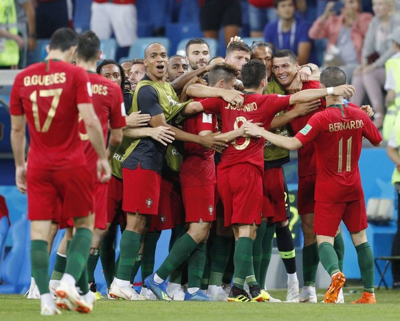 Football: Spain vs Portugal at World Cup Portugal players celebrate after teammate Cristiano Ronaldo (2nd from R) scores the team s 2nd goal during the first half of a 3-3 match against Spain at the W ...