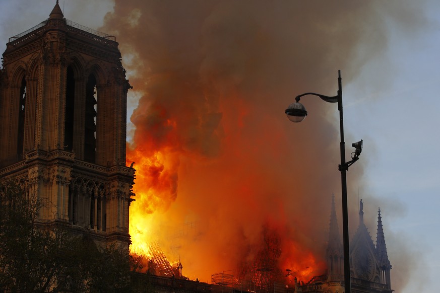 Notre Dame cathedral is burning in Paris, Monday, April 15, 2019. A catastrophic fire engulfed the upper reaches of Paris&#039; soaring Notre Dame Cathedral as it was undergoing renovations Monday, th ...