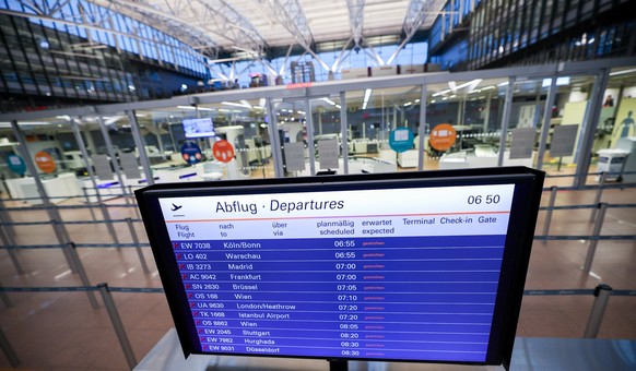 20.04.2023, Hamburg: Auf einem Monitor vor der geschlossenen und menschenleeren Sicherheitskontrolle im Flughafen Hamburg sind alle Abflüge gestrichen. Die Gewerkschaft Verdi hat zu Warnstreiks an dre ...