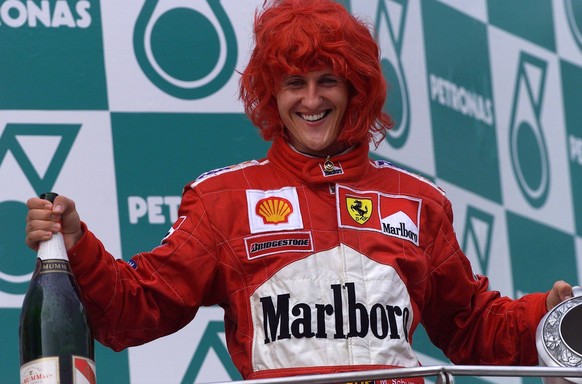 Sepang, Kuala Lumpur, Malaysia. 20-22 October 2000. Michael Schumacher Ferrari celebrates on the podium after winning the Grand Prix and the constructors World Championship, WM, Weltmeisterschaft for  ...