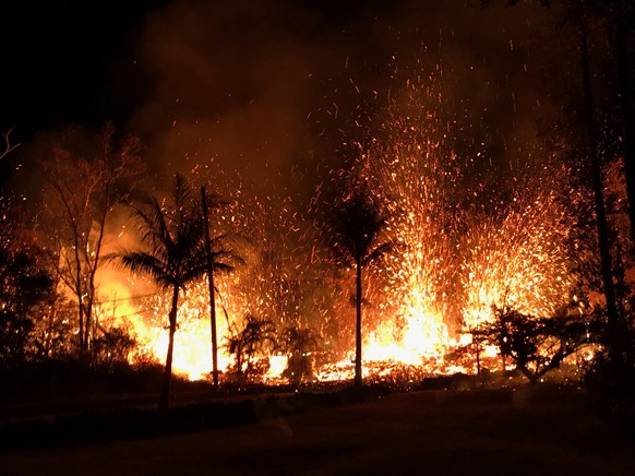 A new fissure spraying lava fountains as high as about 230 feet (70 m), according to United States Geological Survey, is shown from Luana Street in Leilani Estates subdivision on Kilauea Volcano&#039; ...
