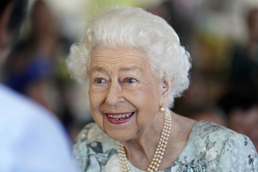 FILE - Britain&#039;s Queen Elizabeth II looks on during a visit to officially open the new building at Thames Hospice, Maidenhead, England July 15, 2022. Buckingham Palace says Queen Elizabeth II is  ...