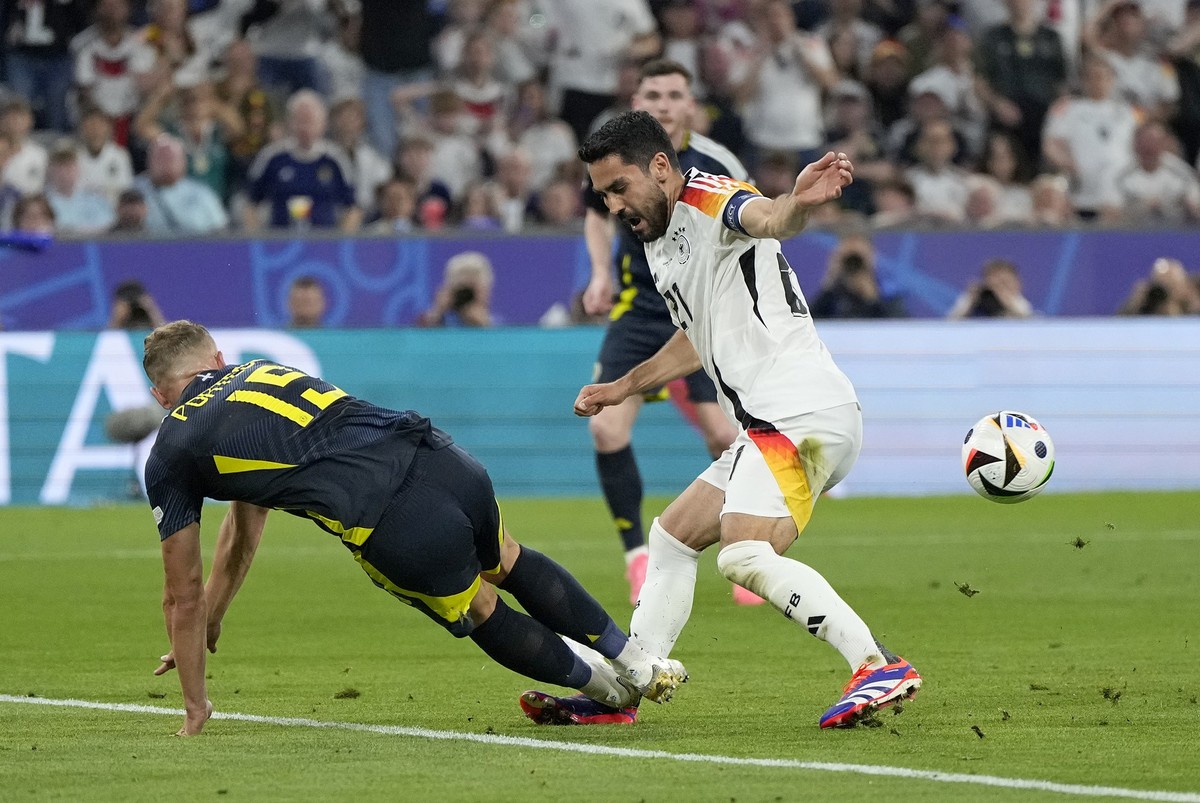 Scotland&#039;s Ryan Porteous, left, fouls Germany&#039;s Ilkay Gundogan to give away a penalty during a Group A match between Germany and Scotland at the Euro 2024 soccer tournament in Munich, German ...