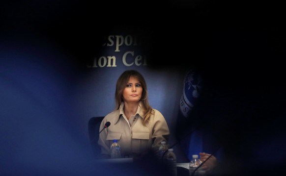 U.S. first lady Melania Trump is framed by cameras filming her as she appears with President Donald Trump at a public event for the first time in almost a month during a hurricane response briefing at ...