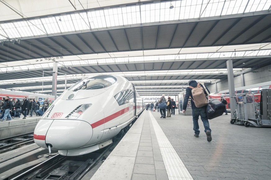 Munich, Germany - March 1, 2014: Intercity Express (ICE) trains at the central station in Munich. Passengers are on the way to boarding.