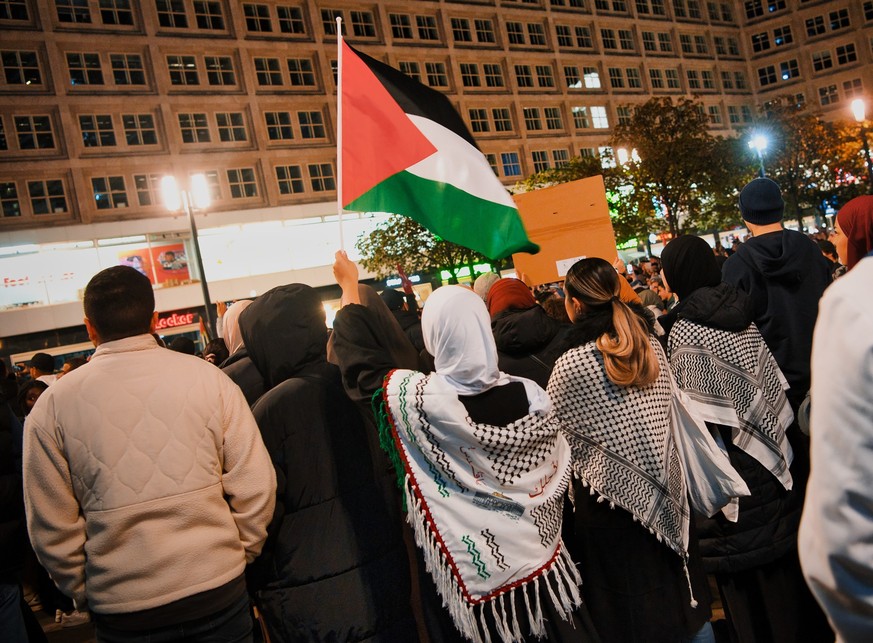 22.10.2023, Berlin: Teilnehmer an einer Pro-Palästina Kundgebung stehen auf dem Alexanderplatz. Nach dem Terrorangriff der Hamas auf Israel vom 7. Oktober kam es auch an diesem Wochenende deutschlandw ...