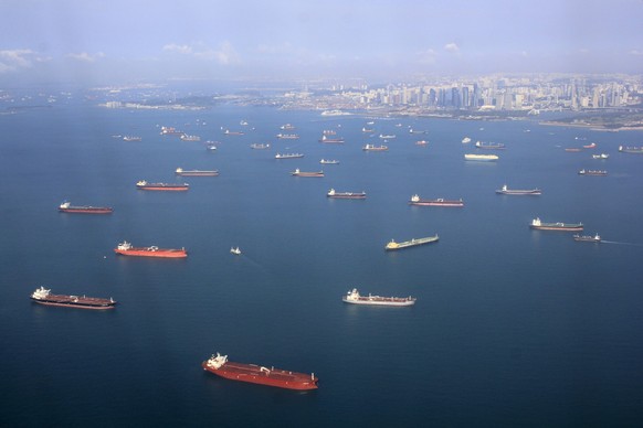 Views of dense rows of boats on the waters of Singapore photographed from aerial view.