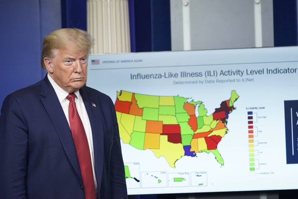 United States President Donald J. Trump looks at a chart as he participates in a news briefing with members of the Coronavirus Task Force at the White House in Washington, DC on April 16, 2020. PUBLIC ...