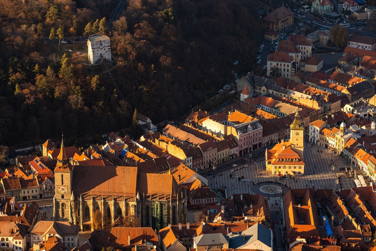 Aerial view of Brasovs historic center with the Black Church and Council Square, Romania, bathed in warm sunlight. 27090104 RECORD DATE NOT STATED