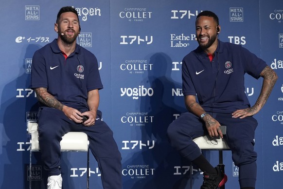 Paris Saint-Germain soccer players, Lionel Messi, left, and Neymar smile during a press conference in Tokyo Sunday, July 17, 2022. Paris Saint-Germain is in Japan for their pre-season tour and will pl ...