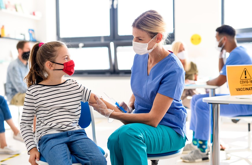 Young child with face mask getting vaccinated, coronavirus, covid-19 and vaccination concept.