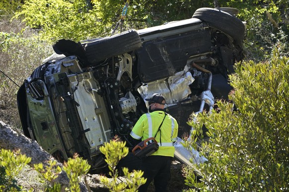 A vehicle rests on its side after a rollover accident involving golfer Tiger Woods Tuesday, Feb. 23, 2021, in Rancho Palos Verdes, Calif., a suburb of Los Angeles. Woods suffered leg injuries in the o ...