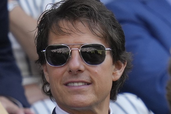 Centre Court is reflected in the sunglasses of film star Tom Cruise as he sits in the Royal Box for the final of the women's singles between Tunisia's Ons Jabeur and Kazakhstan's Elena Rybakina on day ...