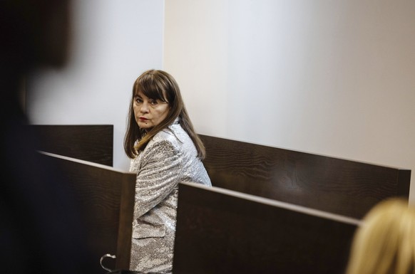 Activist, Justyna Wydrzyńska sits at the court in Warsaw, Poland, on Tuesday March 14, 2023. A court on Tuesday convicted Wydrzyńska for helping a victim of domestic violence access abortion pills in  ...