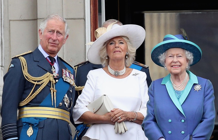 LONDON, ENGLAND - JULY 10: (L-R) Prince Charles, Prince of Wales, Camilla, Duchess of Cornwall, Queen Elizabeth II watch the RAF flypast on the balcony of Buckingham Palace, as members of the Royal Fa ...