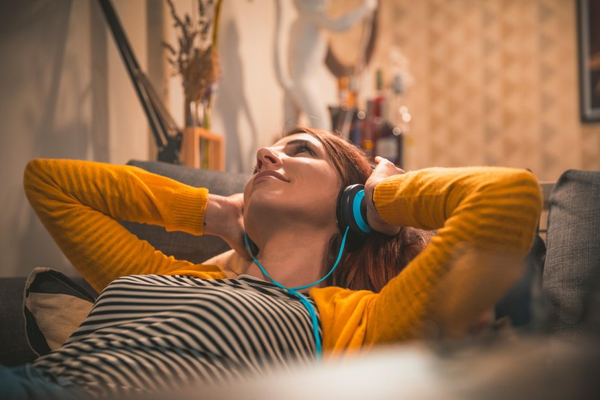 Women at home listening music
