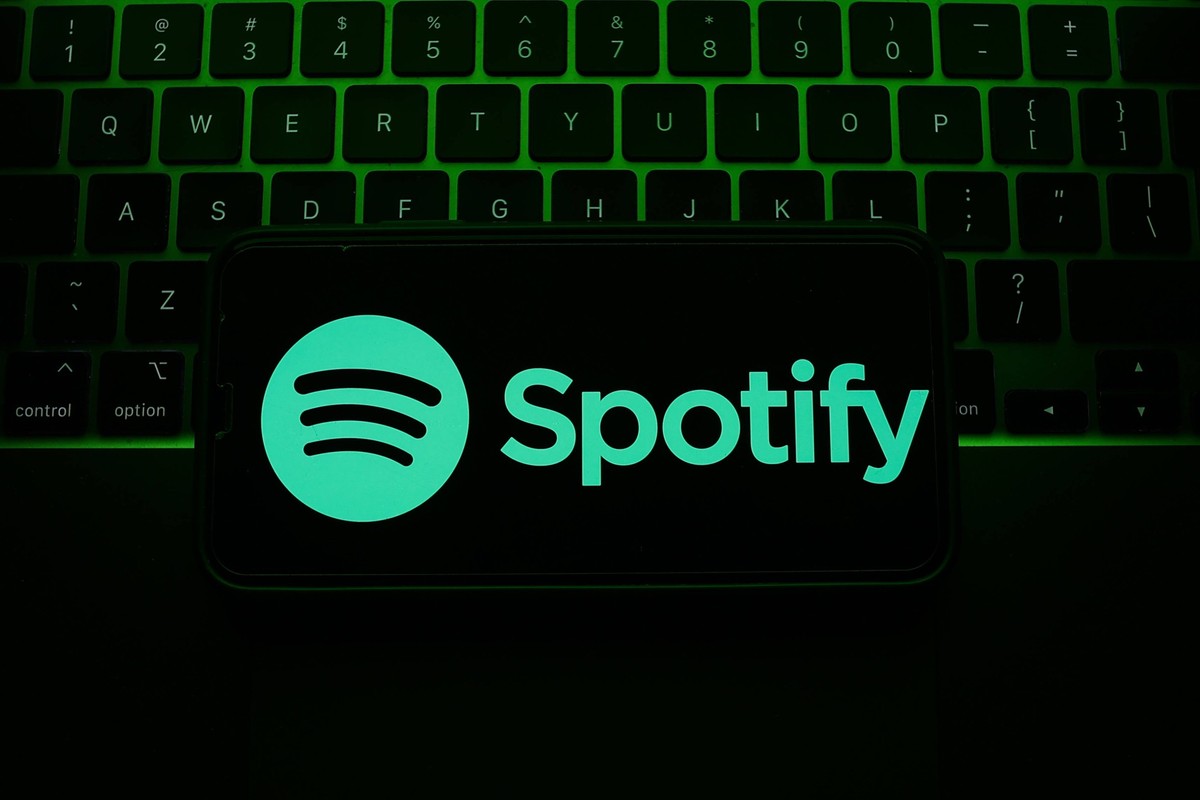 Popular Apps Photo Illustrations A laptop keyboard and Spotify logo displayed on a phone screen are seen in this illustration photo taken in Krakow, Poland on May 7, 2023. Krakow Poland PUBLICATIONxNO ...