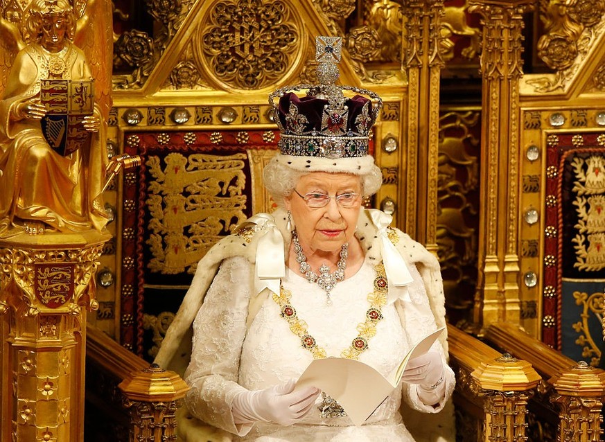 LONDON, ENGLAND - MAY 18: Queen Elizabeth II reads the Queen&#039;s Speech from the throne during State Opening of Parliament in the House of Lords at the Palace of Westminster on May 18, 2016 in Lond ...