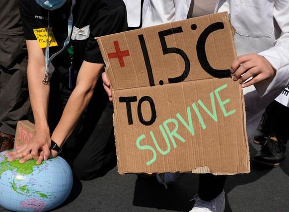 FILE - Demonstrators pretend to resuscitate the Earth while advocating for the 1.5 degree warming goal to survive at the COP27 U.N. Climate Summit, Nov. 16, 2022, in Sharm el-Sheikh, Egypt. United Nat ...