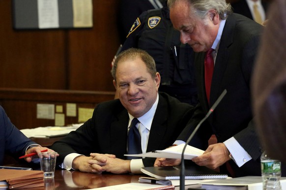 FILE PHOTO: Film producer Harvey Weinstein speaks to his lawyer Benjamin Brafman inside Manhattan Criminal Court during an arraignment in the Manhattan borough of New York, U.S., July 9, 2018. Jeffers ...