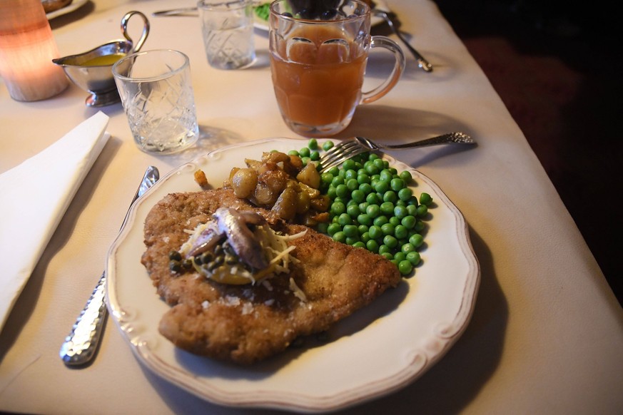 odby/sjaelland / Denmark /04 November 2023/.Wiener schnitzel dish is made of calf beef with green pies and potatoes and home bewed beerdinner dish at udby kroen danish classic restaurant in danish cou ...