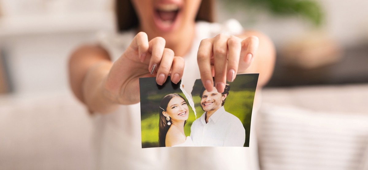 Divorce Concept. Unrecognizable Furious Girl Tearing Apart Photo Of Happy Couple Indoor. Selective Focus, Panorama, Cropped
