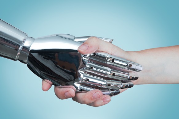Human shaking hands with robot