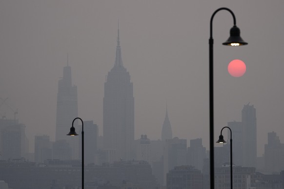 The sun rises over a hazy New York City skyline as seen from Jersey City, N.J., Wednesday, June 7, 2023. Canadian wildfires are blanketing the northeastern U.S. in a haze, turning the air acrid, the s ...