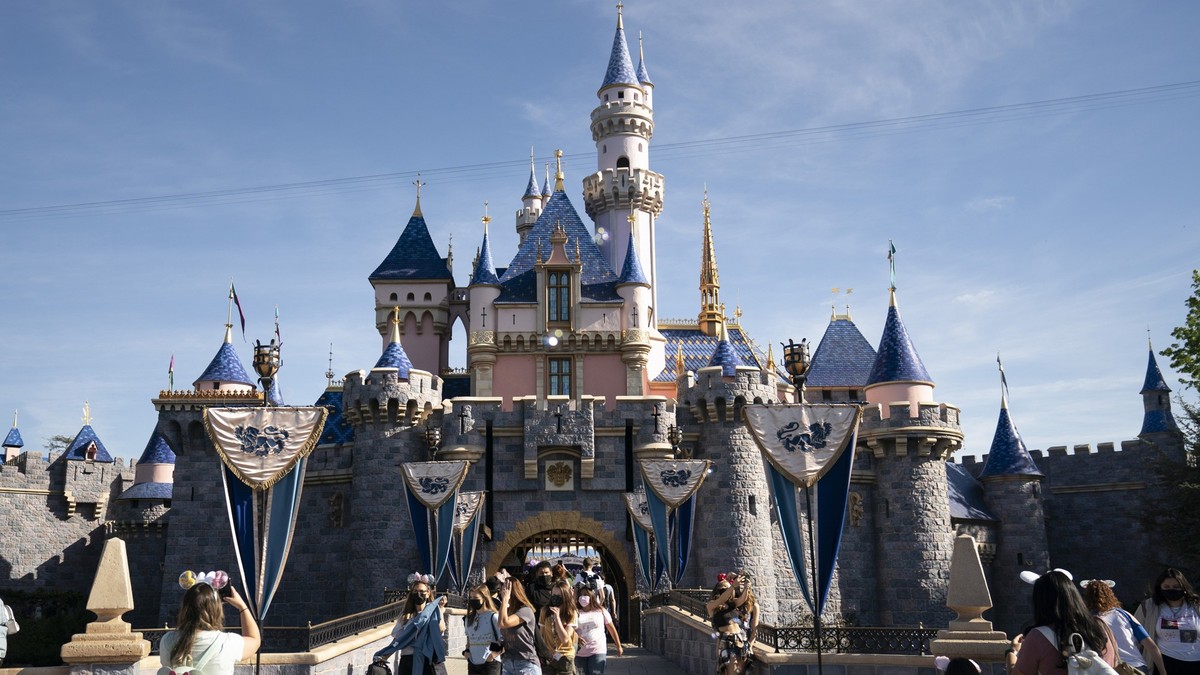 FILE - Visitors pass through Disneyland in Anaheim, Calif., on April 30, 2021. Disney has received a key approval to expand its Southern California theme parks in its first push to make major changes  ...