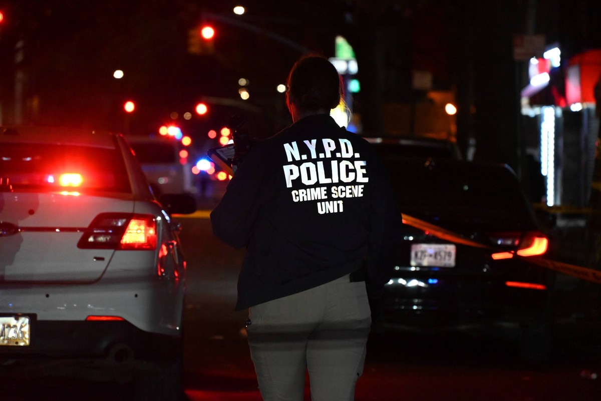 Crime Scene Investigators At Scene Where 29-year-old Man Killed In Shooting In Fleetwood Section Of Bronx New York Crime scene investigators with the NYPD mark evidence at the scene and a vehicle with ...
