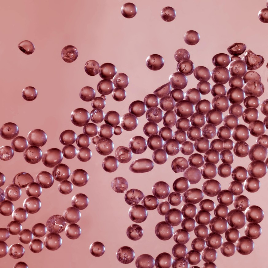 abstract science background showing lots of transparent globules in light red back