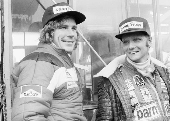 FILE - In this Oct. 24, 1976, file photo, Austrian auto racer Niki Lauda, right, defending champion in world driving, and James Hunt, of Britain, look at the rain before the start of the Japan Grand P ...