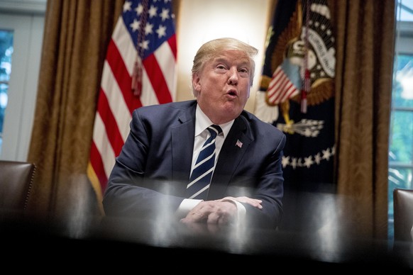 President Donald Trump speaks to members of the media as he meets with members of Congress in the Cabinet Room of the White House, Tuesday, July 17, 2018, in Washington. Trump says he meant the opposi ...
