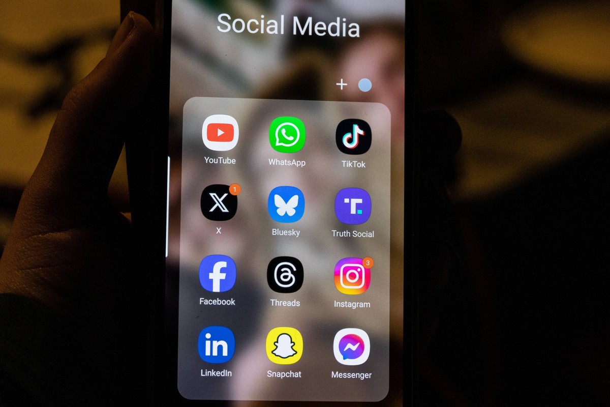 November 19, 2024, Copenhagen, Copenhagen, Denmark: This photo illustration a smartphone screen displays the logo of social media app Bluesky besides L the logo of US online social media and social ne ...