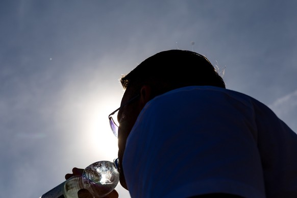 06.04.2024, Brandenburg, Cottbus: Ein Mann trinkt bei frühsommerlichem Wetter Wasser aus einer Flasche. (zu dpa: «Sommerwetter im April - Wetterdienst meldet rekordverdächtige Werte») Foto: Frank Hamm ...