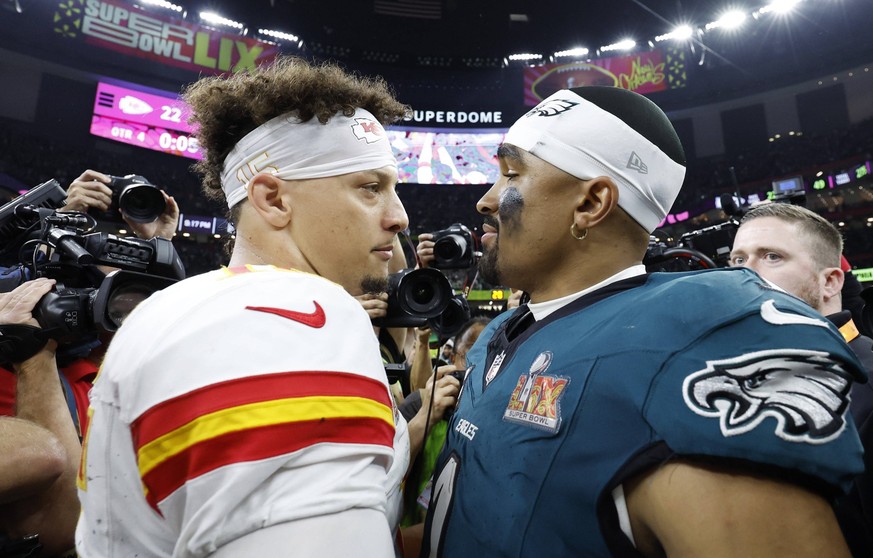 Philadelphia Eagles quarterback Jalen Hurts and Kansas City Chiefs quarterback Patrick Mahomes meet on the field after the Eagles defeat the Kansas City Chiefs 40-22 in Super Bowl LIX at Caesars Super ...